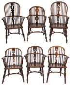 Six early 19th Century stick back Windsor elbow chairs:, five being in yew wood, elm and beech,