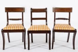 A set of six Regency mahogany dining chairs:, including two elbow chairs,