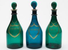 Three Bristol green glass decanters: of typical mallet shaped form with ribbed neck and lozenge