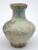 A Chinese green glazed pottery vase, Hu: with waisted neck and globular body,