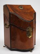 A small George III mahogany and ebony strung cutlery box: of serpentine outline,