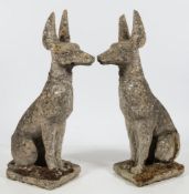 A pair of reconstituted stone figures of Egyptian hunting dogs:,