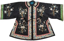 A Chinese silk work court robe: the red field with all over floral designs and panel to the back