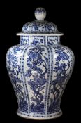 A Chinese octagonal baluster jar and cover: painted in blue with eight panels containing birds and