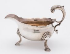 A George II silver sauce boat, maker's mark worn, London, 1752: with wavy edge border,