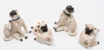 Four Meissen porcelain pug dogs: modelled variously in scratching and grooming poses,