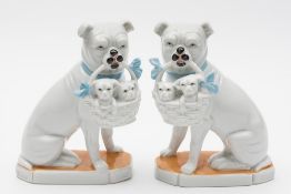 A pair of continental pugs groups: either Austrian or French each modelled seated with a ribbon