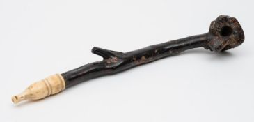 A Chinese black coral and ivory opium pipe: with naturalistic shaped bowl and stem with ivory