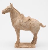 A Chinese painted pottery figure of a horse: with saddle and saddle cloth,