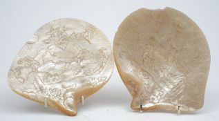 Two Chinese mother of pearl carved shells: decorated with figures amongst a pagoda landscape,