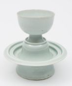 A Chinese Qingbai cup and stand: covered with a light greenish-blue glaze,