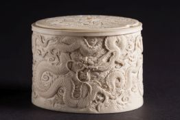 A Japanese ivory tusk box and cover: of oval outline, with lift-off lid,