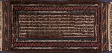 A Belouchistan rug:, the geometric striped and serated field enclosed by a geometric Calyx border,