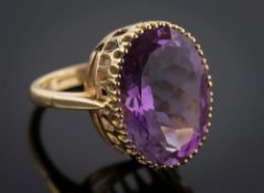 An 18ct gold and oval amethyst single-stone dress ring: the oval amethyst approximately 19.