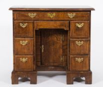 An 18th Century walnut and feather banded kneehole desk:, of small size,
