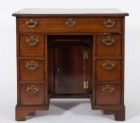 An 18th Century mahogany and inlaid kneehole desk:, of small size,