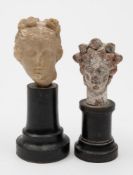 A small carved marble head: mounted on an ebonised stand, 10.5cm.