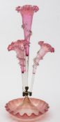 A pale cranberry and white tinged glass epergne: with central trumpet shaped vase with pinched