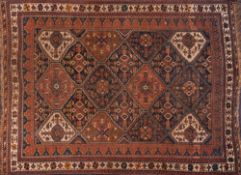 An Afshar rug:, the stepped lozenge geometric panelled field with stylised designs,