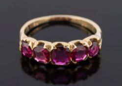 A late 19th century gold and ruby five-stone ring: with graduated round rubies estimated to weigh 0.