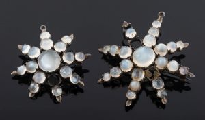 A moonstone mounted, star shaped pendant/brooch together with a similar,