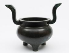 A large Chinese bronze tripod censer: with globular body,