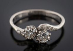 A diamond two-stone cross over ring: with circular-cut diamonds estimated to weigh a total of 0.