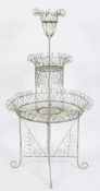 A painted wirework circular graduated three tier conservatory plant stand:, in the Victorian manner,