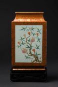 A pair of Chinese coral-ground famille rose vases: of slender rectangular section with waisted neck