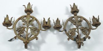 A pair of Arts and Crafts period wall lights: the circular frame with three sconces and decorated