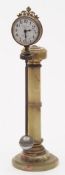 An Edwardian onyx mystery clock: having an eight-day duration timepiece movement set within a