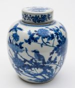 A Chinese blue and white ginger jar and cover: painted with birds amongst tree peonies,