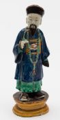 A Chinese sancai glazed figure of an official: wearing a blue robe and long necklace,