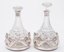 A pair of silver plated coasters: of circular form,