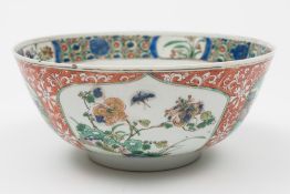 A Chinese porcelain famille verte bowl: the exterior enamelled with panels of peony, chrysanthemum,