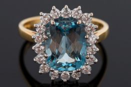 A aquamarine and diamond cushion-shaped cluster ring: with central cushion-shaped aquamarine 10.