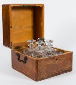 A 19th century French decanter set in marquetry case: with inlaid floral decoration to the top and