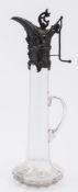 A late Victorian clear glass and plate mounted claret jug: the slender neck surmounted with a lever