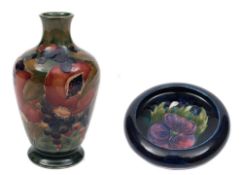 A Moorcroft pottery vase and dish: the former of footed bottle shaped form tubelined in the