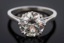 A platinum and diamond single-stone ring: the circular brilliant-cut stone approximately 9.