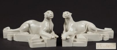 P Trudeau, a pair of faux marble models of recumbent panthers: in the Art Deco taste,