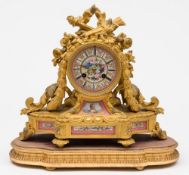 A French ormolu and porcelain mantel clock: the eight-day duration movement striking the hours and