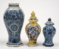 Three small Dutch delft vases: the largest of octagonal baluster form painted in blue with foliage