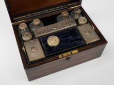 A Victorian rosewood lady's vanity case for Asprey: the rectangular case with brass stringing,