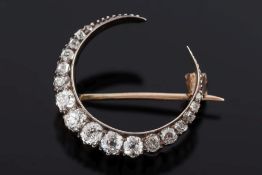 A 19th century diamond crescent brooch: with graduated cushion shaped,