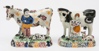 Two early 19th Century pottery cow groups: probably Yorkshire, one with a milkmaid and calf,