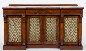 An early Victorian mahogany sideboard:, of recessed breakfront outline, having a later ledge back,
