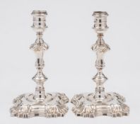 A pair of George II cast silver candlesticks, maker William Cafe, London, 1758: crested,