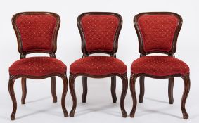 A set of six Victorian mahogany dining chairs:, in the French taste with upholstered cartouche,