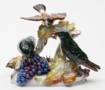 A Meissen group of birds: in the form of two starlings and a sparrow perched on vine branches and